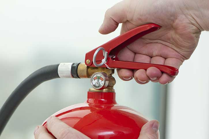 Fire extinguisher in use